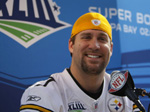 Ben answers questions for a little boy with a press pass.