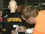 Screen capture: Ben signs Joseph's jersey.