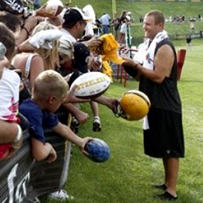 A shoe-less Ben signs autographs after practice on July 31st. 
